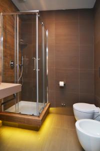 a bathroom with a shower and a toilet and a sink at Bed In Centro in Naples
