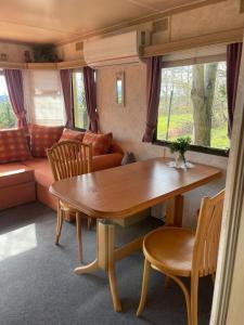 a living room with a table and a couch at Noclegi Bajama in Siepraw