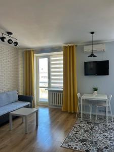 a living room with a couch and a table at Sisters apartment Val in Chernihiv