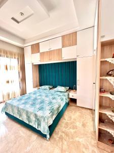 a bedroom with a large bed and a closet at SBB Home Mahdia in Mahdia