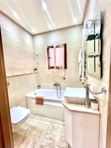 a bathroom with a tub and a sink and a toilet at SBB Home Mahdia in Mahdia +10 photos