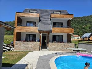 a house with a swimming pool in front of it at Drinski Zamak in Vrhpolje