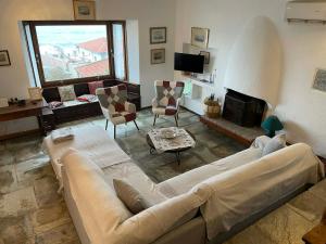 a living room with a couch and a fireplace at Panagopoulos House in Agios Ioannis Pelio