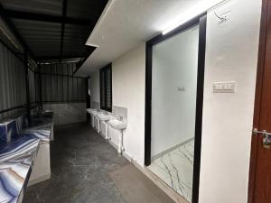 a bathroom with sinks and toilets in a building at Cozstel in Kozhikode +4 photos