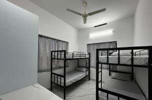 a room with two bunk beds and a ceiling fan at Cozstel in Kozhikode