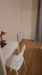 a room with a table and two chairs and a lamp at Sweet Lodge in Échirolles +7 photos