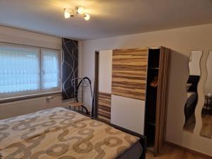 a bedroom with a bed and a closet at Ferienwohnung Lux in Markische Heide