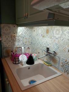 a kitchen counter with a sink in a kitchen at iliolithos rooms in Kardamyli +73 photos