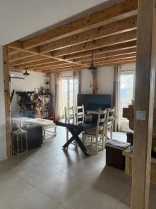 a dining room with a table and chairs in a room at Les Crins Du Bonheur Chambre et Table Hôtes Belle Vue in Fraisse