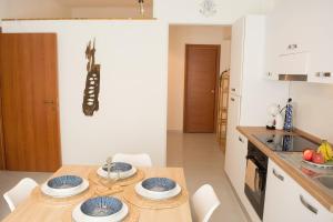 a kitchen with a table with blue and white plates on it at Velaria Apartment in Termoli