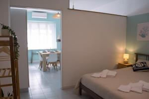 a bedroom with a bed and a dining room at Velaria Apartment in Termoli +29 photos