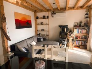 a living room with a couch and a table at Les Crins Du Bonheur Chambre et Table Hôtes Belle Vue in Fraisse