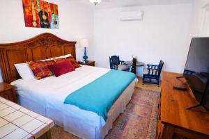 a bedroom with a large bed and a flat screen tv at La Quinta en Alamos in Álamos +71 photos