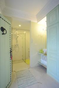a bathroom with a shower and a glass door at Dar Antonia in Sousse +86 photos