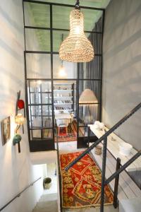 a room with a staircase with a chandelier at Dar Antonia in Sousse