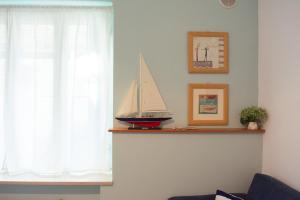 a shelf with a sail boat on it next to a window at Velaria Apartment in Termoli