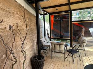 a patio with chairs and tables and a wall at Azat - Toon in Garni