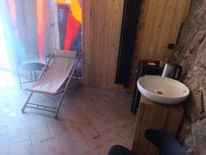 a bathroom with a chair and a sink at Azat - Toon in Garni