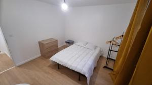 a bedroom with a white bed and a wooden floor at 8C - L'Urban in Saint-Rambert-dʼAlbon +3 photos