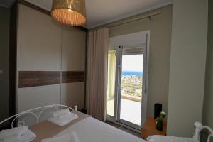 a bedroom with a large mirror and a large window at Thea Hill in Kritharia +26 photos