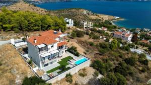an aerial view of a house with a swimming pool at Thea Hill in Kritharia