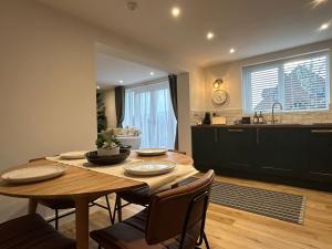 a kitchen and dining room with a wooden table and chairs at Westwinds View in Ludlow