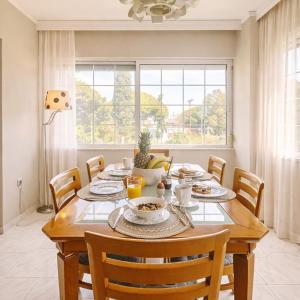 a dining room with a wooden table and chairs at Erofili's Apartment ONLY 700 meters from the beach in Ialysos