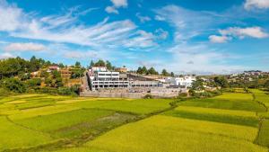 a village in the middle of a green field at Ricefield Valley in Mandrangobato