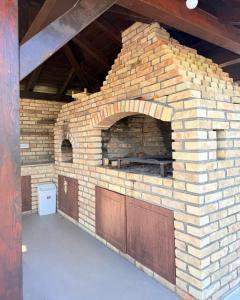 a brick oven in the middle of a building at Vikendoria Pool House & Events in Bački Jarak