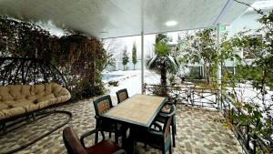 an outdoor patio with a table and a couch at Qebele hot pool in Gabala