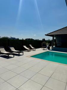 a patio with chairs and a swimming pool at Vikendoria Pool House & Events in Bački Jarak