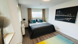 a hotel room with a bed with blue pillows at Miras Guesthouse Ferienwohnung in Lengerich