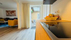 a kitchen with a counter with a bowl of fruit on it at Miras Guesthouse Ferienwohnung in Lengerich