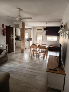a living room and kitchen with a table and chairs at Apartamento Buendia in Buendía