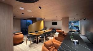 a living room with a table and some chairs at Cabo Branco Flat Amsterdam in João Pessoa