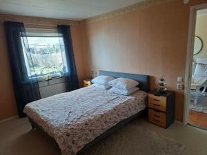 a bedroom with a large bed and a window at Villa Glumslov in Landskrona