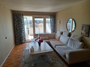 a living room with a couch and a table at Villa Glumslov in Landskrona