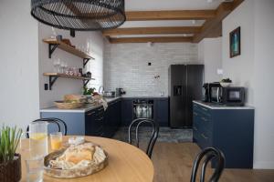 a kitchen with a table and chairs in a room at Willa Widokowe Wzgórze in Falsztyn