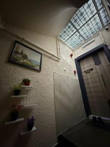 a bathroom with a skylight and a door with plants at Royal Konaklama Manzara in Bandırma