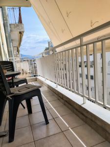 a balcony with a table and a chair on a building at Vasiliki's apartment in Serres