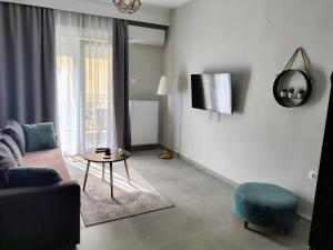 a living room with a couch and a table at Vasiliki's apartment in Serres