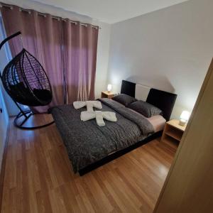 a bedroom with a bed with two towels on it at Apartman Zivkovic in Bosanska Dubica