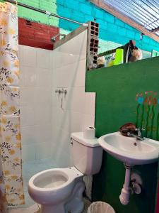 a bathroom with a toilet and a sink at El hada de Yumbilla in Cuispes