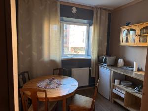 a small kitchen with a table and a window at 1-bedroom 2 big beds MV64 in Tartu