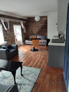 a kitchen and living room with a couch and a table at Stay in Annascaul Village at Aido's in Anascaul