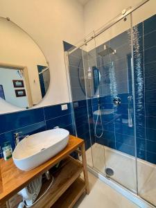 a bathroom with a sink and a shower at Lemontree House Bacoli in Bacoli +61 photos