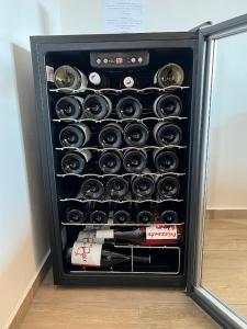 a black refrigerator filled with bottles of wine at Apartmán vinařství U Krčků in Zaječí