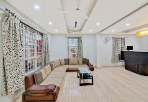 a living room with a couch and a piano at Super Hotel O Pioneer in Pune
