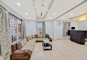 a living room with a couch and a piano at Super Hotel O Pioneer in Pune