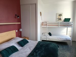 a bedroom with two bunk beds and a red wall at GITE LA NOTARIALE in Combles